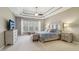 Spacious main bedroom featuring tray ceilings, neutral paint, and large windows at 5365 Vendelay Ln, Cumming, GA 30040