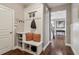 Entryway mudroom featuring a built-in bench with storage and coat hooks at 5365 Vendelay Ln, Cumming, GA 30040