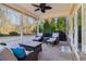 Outdoor patio with comfortable seating, ceiling fan, grill, and view of landscaped backyard at 5365 Vendelay Ln, Cumming, GA 30040