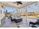 Spacious patio with ample seating, ceiling fan, and a beautiful view of the wooded backyard at 5365 Vendelay Ln, Cumming, GA 30040