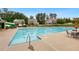 Community pool featuring a slide, lounge chairs, and several lap lanes for swimming and recreation at 5365 Vendelay Ln, Cumming, GA 30040