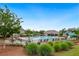 Community pool area with lounge chairs, umbrellas, and a slide surrounded by lush landscaping at 5365 Vendelay Ln, Cumming, GA 30040