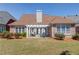 Backyard featuring patio, manicured landscaping, and brick exterior at 836 Windsor Place Ct, Grayson, GA 30017