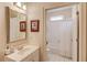 Bright bathroom with a vanity, framed mirror, and a combination tub and shower with white tiling at 836 Windsor Place Ct, Grayson, GA 30017