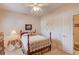 Cozy bedroom showcasing a four-poster bed with ornate details, a ceiling fan, and a side table with a lamp at 836 Windsor Place Ct, Grayson, GA 30017