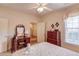 Bedroom with a ceiling fan, a writing desk with a mirror, and a window letting in natural light at 836 Windsor Place Ct, Grayson, GA 30017