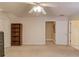 Neutral carpeted bedroom featuring ceiling fan and convenient access to doorways and built in shelving at 836 Windsor Place Ct, Grayson, GA 30017
