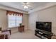 Bonus room features a ceiling fan, a window with blinds, and media center with a television at 836 Windsor Place Ct, Grayson, GA 30017