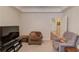 Bonus room with neutral walls and carpeting and featuring a television and comfortable armchairs at 836 Windsor Place Ct, Grayson, GA 30017