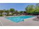 Large, inviting community pool with lounge chairs and umbrellas on a sunny day at 836 Windsor Place Ct, Grayson, GA 30017