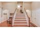 Grand foyer with a staircase, wooden floors, white trim, and arched doorways at 836 Windsor Place Ct, Grayson, GA 30017