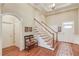 Bright foyer with hardwood floors, staircase, and decorative bench seating at 836 Windsor Place Ct, Grayson, GA 30017