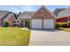 Charming brick home with attached two car garage and well-manicured lawn at 836 Windsor Place Ct, Grayson, GA 30017