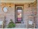 Inviting front porch with rocking chairs, brick walls and decorative plants at 836 Windsor Place Ct, Grayson, GA 30017
