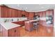 Spacious kitchen features wood cabinets, stainless appliances, and a breakfast bar at 836 Windsor Place Ct, Grayson, GA 30017