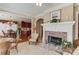View of living room with fireplace, open to dining room and kitchen at 836 Windsor Place Ct, Grayson, GA 30017