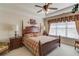 Main bedroom suite featuring tray ceiling, and large window at 836 Windsor Place Ct, Grayson, GA 30017