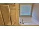 Bathroom features a tub, shower, and window with white blinds at 1021 Rock Elm Dr, Auburn, GA 30011