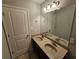 Bathroom features a dual sink vanity, large mirror, and great lighting at 1021 Rock Elm Dr, Auburn, GA 30011