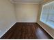 Cozy bedroom featuring hardwood floors and a window with natural light at 1021 Rock Elm Dr, Auburn, GA 30011
