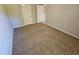 Bedroom with carpet flooring and neutral colored walls with two doors at 1021 Rock Elm Dr, Auburn, GA 30011