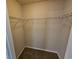 Walk in closet featuring carpeted floor, base trim and shelving at 1021 Rock Elm Dr, Auburn, GA 30011