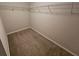 Walk-in closet with carpet floors and metal shelving for organized storage at 1021 Rock Elm Dr, Auburn, GA 30011