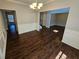 Dining room featuring hardwood floors, modern lighting, and wainscoting at 1021 Rock Elm Dr, Auburn, GA 30011