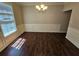 Dining room featuring hardwood floors, modern lighting, and wainscoting at 1021 Rock Elm Dr, Auburn, GA 30011