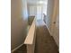 Upstairs hallway with carpet flooring and neutral colored walls at 1021 Rock Elm Dr, Auburn, GA 30011