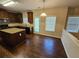 Open-concept kitchen with island, dark wood cabinets and stainless steel appliances at 1021 Rock Elm Dr, Auburn, GA 30011