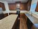 Updated kitchen with stainless steel appliances, granite counters, and dark wood cabinets at 1021 Rock Elm Dr, Auburn, GA 30011