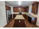 Spacious kitchen with dark wood cabinets, granite countertops, and modern appliances at 1021 Rock Elm Dr, Auburn, GA 30011