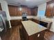 Large kitchen with granite counters, stainless appliances, and dark wood cabinets at 1021 Rock Elm Dr, Auburn, GA 30011