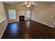 Bright living room featuring dark wood floors, fireplace, and neutral walls at 1021 Rock Elm Dr, Auburn, GA 30011