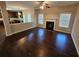 Inviting living room with a fireplace, dark wood floors, and plenty of natural light at 1021 Rock Elm Dr, Auburn, GA 30011