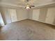 Large main bedroom offering a ceiling fan, neutral paint, and carpeting at 1021 Rock Elm Dr, Auburn, GA 30011