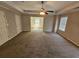 Spacious main bedroom boasting a tray ceiling, ceiling fan, and a connecting room at 1021 Rock Elm Dr, Auburn, GA 30011