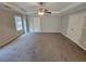 This bright main bedroom includes a ceiling fan, and neutral colored walls at 1021 Rock Elm Dr, Auburn, GA 30011