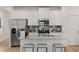 Modern kitchen with white cabinets, stainless steel appliances, granite countertops and an island with stool seating at 1029 Merritt Dr # 97, Villa Rica, GA 30180