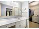 Bathroom featuring dual mirrors, a spacious vanity, and a walk-in closet at 1879 Beaver Dam Ne Ln, Marietta, GA 30062