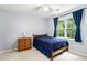Bedroom featuring large window with blue curtains and ample natural light at 1879 Beaver Dam Ne Ln, Marietta, GA 30062
