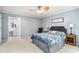 Bright bedroom with ceiling fan, blue accents, ensuite bathroom and comfortable carpet at 1879 Beaver Dam Ne Ln, Marietta, GA 30062