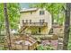 Yellow two-story home featuring multiple decks and a spacious backyard surrounded by mature trees at 1879 Beaver Dam Ne Ln, Marietta, GA 30062