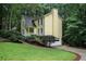 Well-maintained home with a lawn, mature landscaping, and a driveway leading to a garage at 1879 Beaver Dam Ne Ln, Marietta, GA 30062
