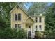 Charming yellow two-story home with white trim and mature landscaping at 1879 Beaver Dam Ne Ln, Marietta, GA 30062