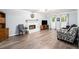 Cozy living room with a fireplace, hardwood floors, and plenty of natural light at 1879 Beaver Dam Ne Ln, Marietta, GA 30062