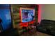 Unique basement bar area with an illuminated display, wooden panels, seating, and barware at 5814 Highgrove Dr, Atlanta, GA 30349