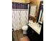 Stylish bathroom with modern fixtures, wood paneled walls, and a decorative shower curtain at 5814 Highgrove Dr, Atlanta, GA 30349