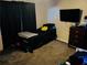 Comfortable bedroom with plush carpet, dresser, and a wall-mounted television at 5814 Highgrove Dr, Atlanta, GA 30349